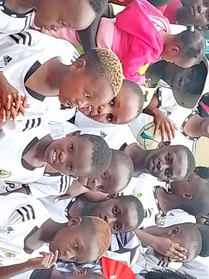 Pre-match huddle in white — Unity Sports Club, Nanyuki