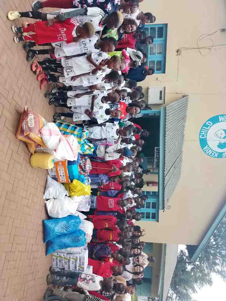Unity Sports Club donation handover with players and supplies