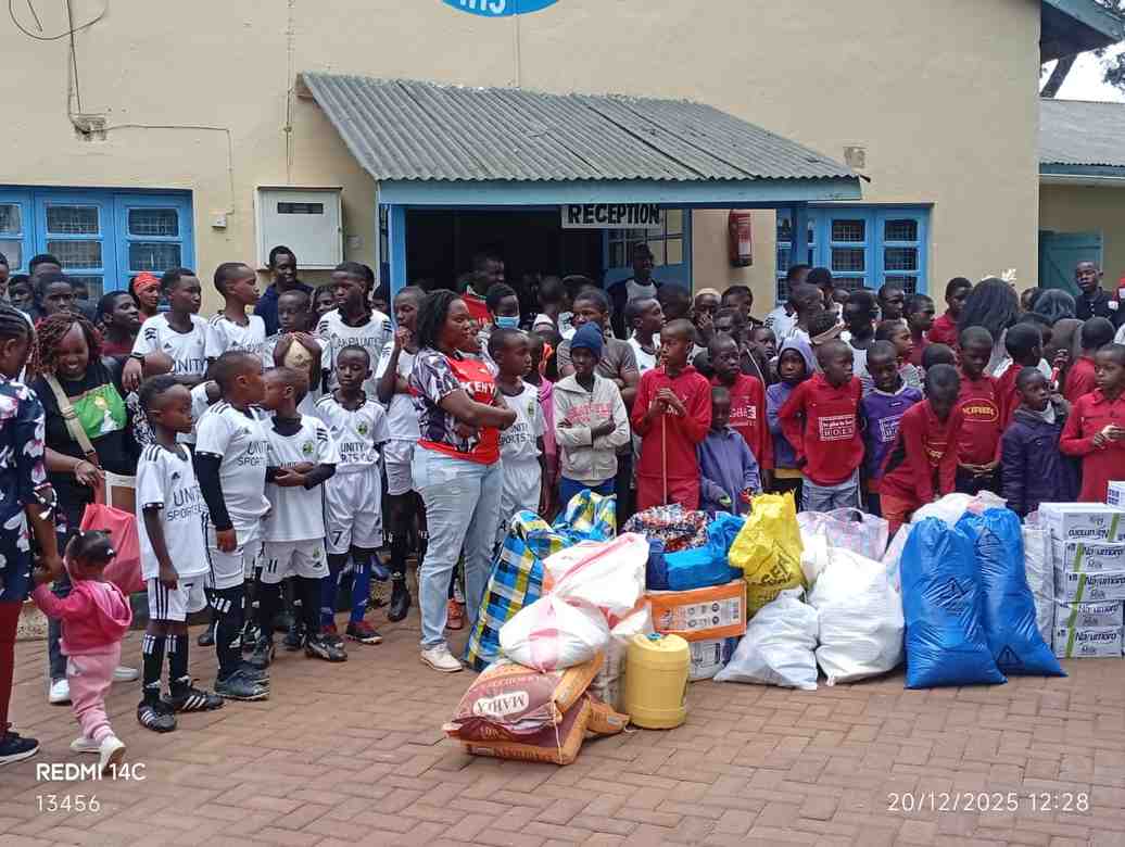 Unity Sports Club players and officials at a children's welfare home visit